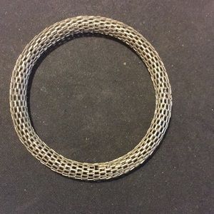 2 Metal interlocking bracelets. One is smaller.
